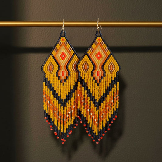 Handgewebte Statement-Ohrringe Sinfonia d'Oro von EDELATELIER. mit Rautenmuster in Ocker, Schwarz und Orange an einem goldfarbenen Stab.