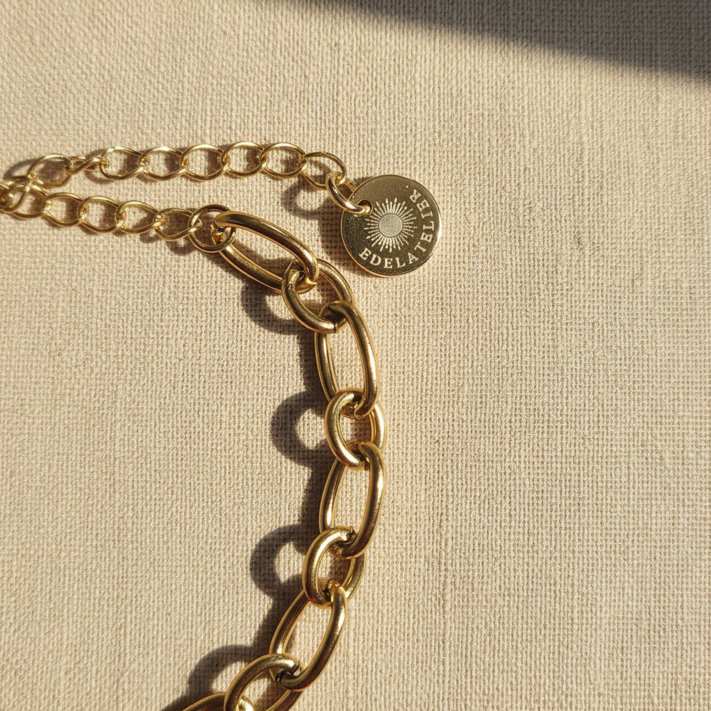 Detailaufnahme des Catena Gliederarmbands mit Karabinerverschluss, Verlängerungskette und EDELATELIER Logo-Plättchen.