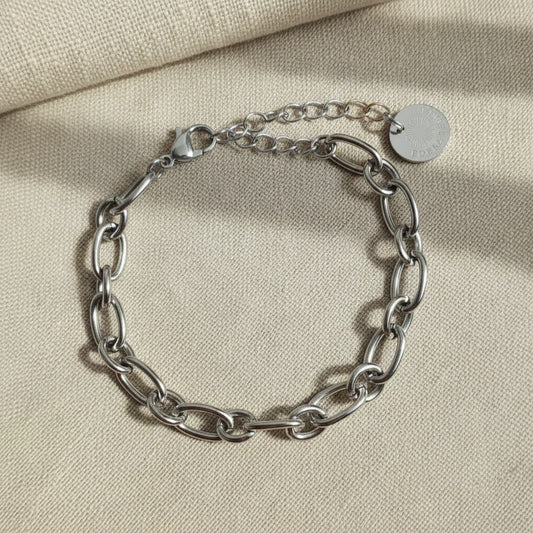 Catena Armband silberfarben aus Edelstahl mit EDELATELIER Logo-Plättchen auf hellem Leinenstoff